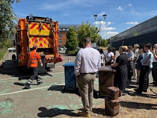Students watching a demonstration of how the refuse collection vehicle works