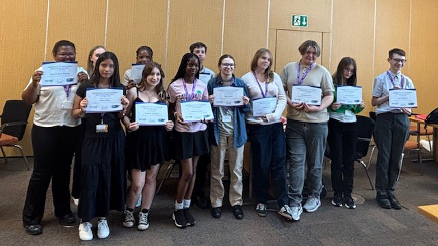 Work experience students with certificates presented by the Deputy Chief Executive